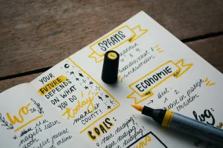 blue marker on white printer paper by Estée Janssens courtesy of Unsplash.